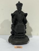 An oriental heavy bronzed figure of a seated official. 9" high.