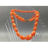 AN ORANGE BEAD NECKLACE