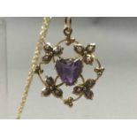 AN EDWARDIAN NINE CARAT GOLD AMETHYST AND SEED PEARL PENDANT ON GOLD CHAIN