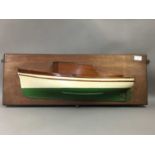 A DECORATIVE WOODEN HALF HULL YACHT MODEL