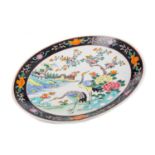 AN EARLY 20TH CENTURY CHINESE FAMILLE NOIRE CIRCULAR PLAQUE