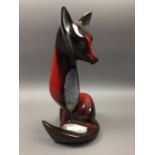 A CERAMIC FIGURE OF A FOX