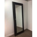 A LEATHER FRAMED MIRROR