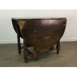 AN OAK DROP LEAF DINING TABLE