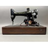 A VINTAGE PORTABLE SINGER SEWING MACHINE