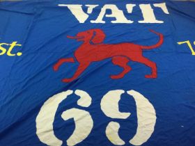 A LARGE ADVERTISING FLAG FOR VAT 69 WHISKY WITH EMBROIDERED DOG LOGO
