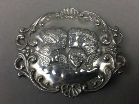 A SILVER BROOCH DEPICTING REYNOLD'S ANGELS, ALONG WITH PLATED BELT AND SPOON
