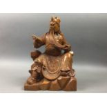 POTTERY FIGURE OF A SEATED BUDDAH AND A CHINESE CARVED WOOD FIGURE