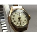 NINE CARAT GOLD CASED LADY'S WRIST WATCH AND OTHER WATCHES