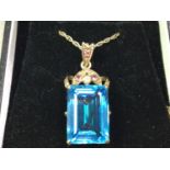 NINE CARAT GOLD, TOPAZ AND DIAMOND PENDANT