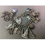 SILVER CHARM BRACELET ALONG WITH TWO SILVER ALBERT CHAINS AND A FOB
