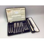 SET OF SIX SILVER HANDLED DESSERT KNIVES AND FORKS, IN A FITTED CASE