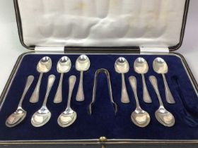 SET OF ELEVEN SILVER TEASPOONS AND SUGAR TONGS, ALONG WITH A SET OF SIX SILVER TEASPOONS