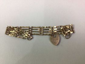 NINE CARAT YELLOW GOLD GATE BRACELET, AND TWO NINE CARAT GOLD CHAINS