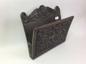 CELTIC REVIVAL CARVED OAK PAPER RACK, AND A SMALL JOINT STOOL