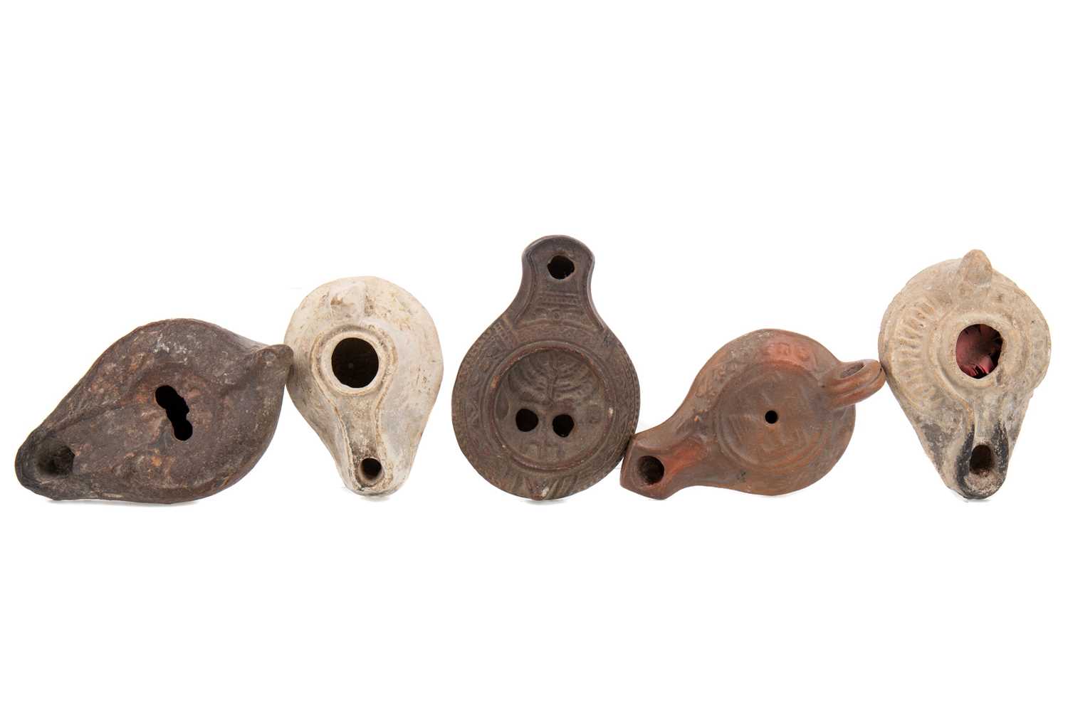 A GROUP OF FIVE ANCIENT ROMAN TERRACOTTA OIL LAMPS