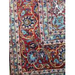 A PERSIAN BORDERED CARPET