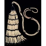 Costume jewellery.  An imitation pearl and black plastic sautoir, c1930,  drop 22.5cm The collection