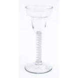 An English wine glass, c1760, the pan-topped round funnel bowl on single series opaque twist stem,