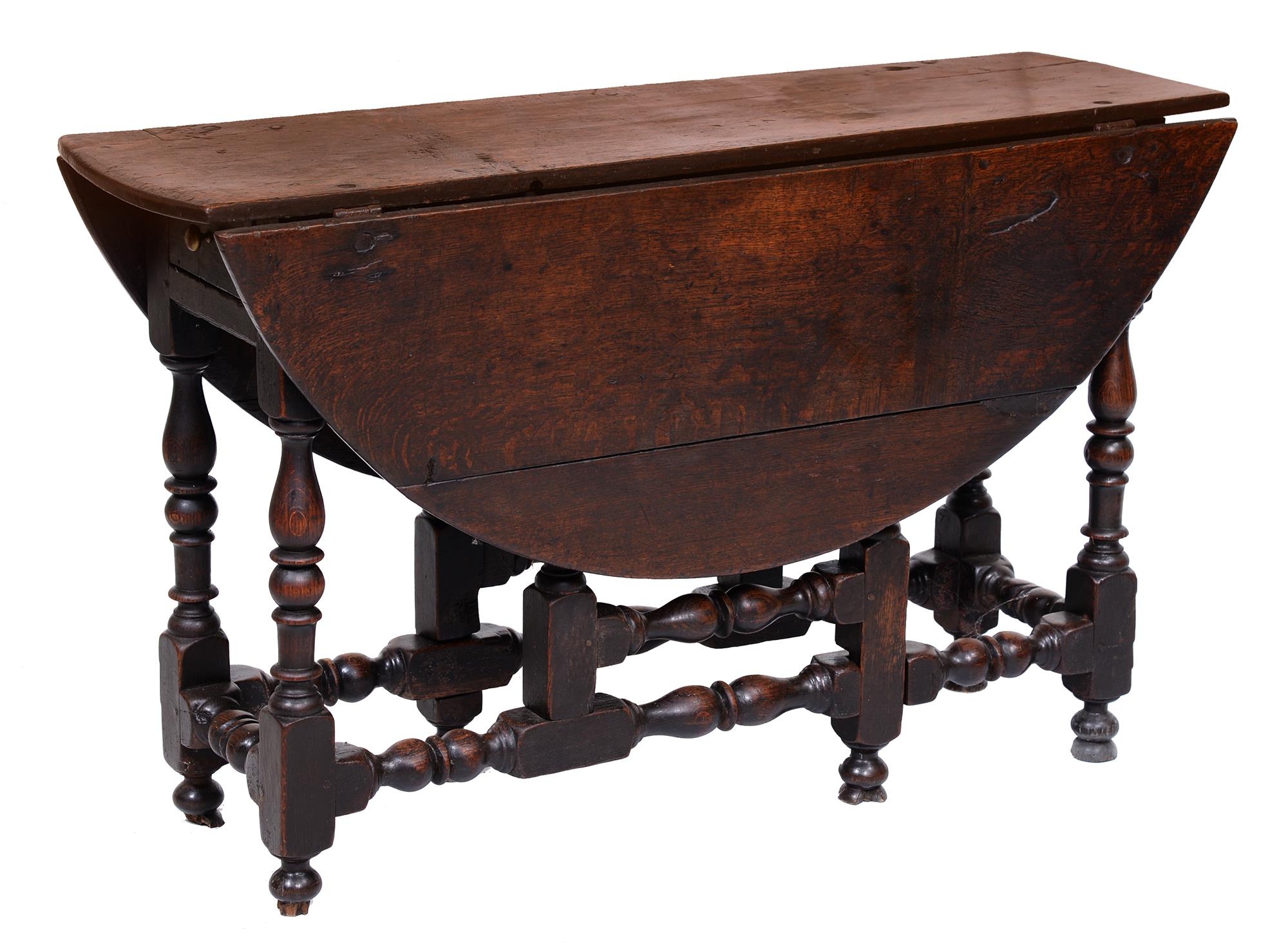 A Queen Anne oak gateleg table, with baluster legs, 73cm h; 117 x 123cm The collection of C. W.