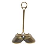 A Victorian brass mounted twin horse hoof doorstop, with ring handle, each hoof applied with the