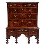 A George I walnut and feather banded chest on stand, 127cm h; 54 x 103cm The collection of C. W.