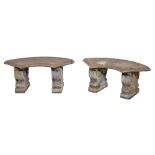 A pair of reconstituted stone garden benches, the quarter circular slab on volute blocks, 38cm h,