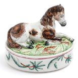 A Staffordshire earthenware egg box, c1860, the cover in the form of a recumbent pony, 18cm h The