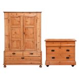 A Victorian pine chest of drawers and a pine wardrobe, with panelled doors above three drawers,