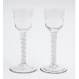 Two English wine glasses, c1770, the ogee bowl engraved with trailing flowers, on multiple series