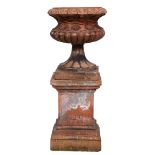 A Victorian terracotta garden vase and pedestal, the lobed campana bowl with fruiting grapevines, on