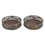 A pair of George III neo classical pierced and engraved silver wine coasters, with beaded rims,