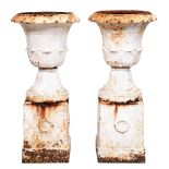 A pair of Victorian cast iron garden vases, of campana shape with acanthus leaves, on contemporary