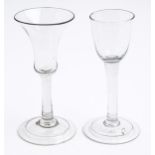 Two English wine glasses, c1750, with round funnel or waisted bell bowl on solid stem, with or