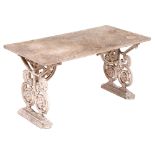 A garden bench, the rectangular marble slab on ornate cast metal end supports united by a stretcher,