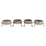 A pair of George III silver salt cellars and a larger similar pair of Victorian silver salt cellars,