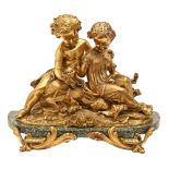 A gilt bronze sculpture of two children with a bird's nest, 19th / 20th c, on green marble