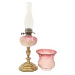 A Victorian brass oil lamp, with shaded pink moulded glass fount of cut cornered square form,