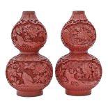 A pair of Chinese cinnabar lacquer double gourd vases, 20th c, each bulb carved with two reserves of