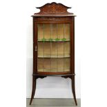 An Edwardian bow centred mahogany and line inlaid china cabinet, with leaded glass door, on