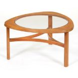 A teak coffee table, c1960, with round plate glass inset top, 43cm h; 76cm diam Faded, good