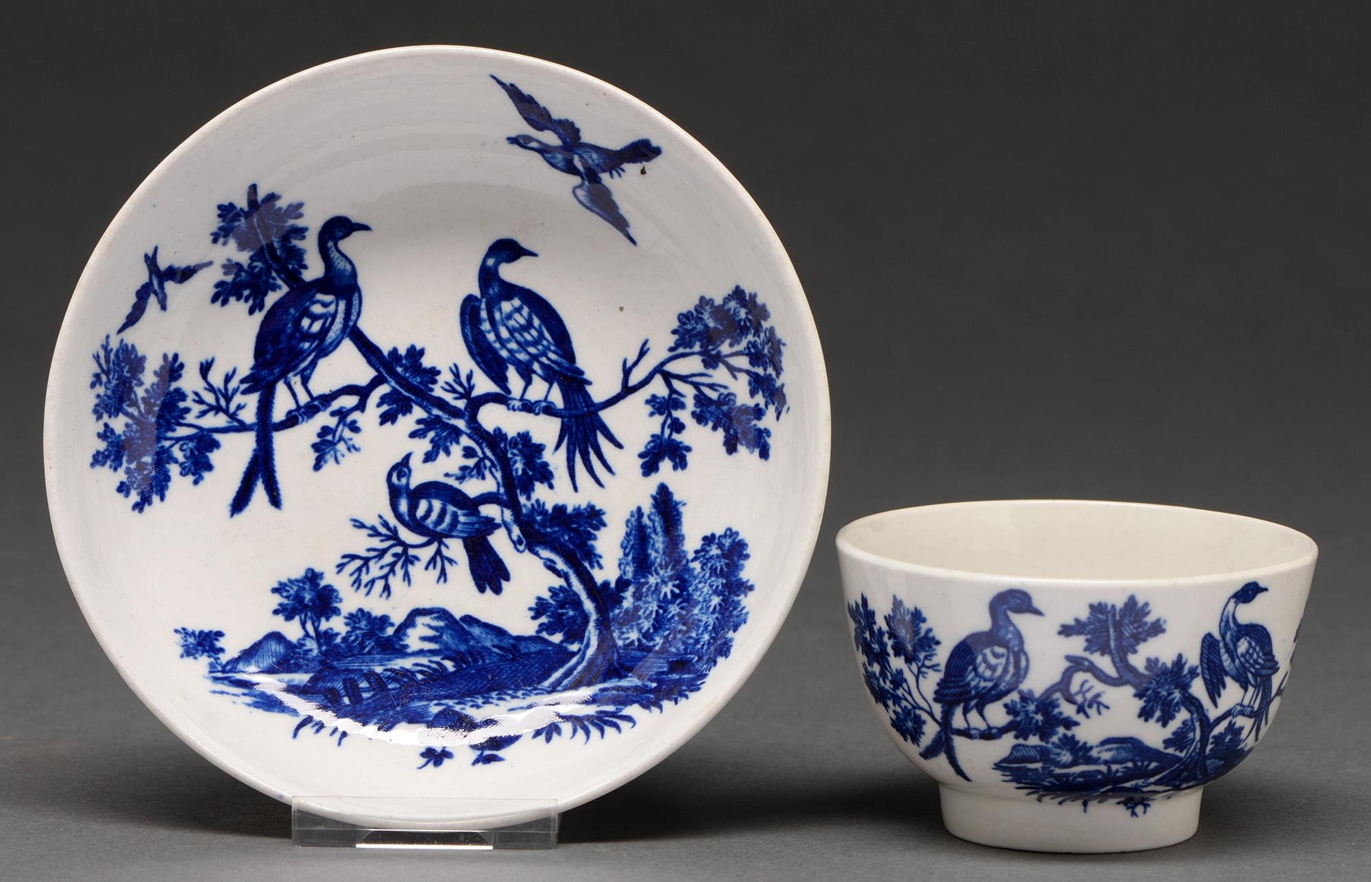 A Worcester blue and white tea bowl and saucer, c1780, transfer printed in bright underglaze blue