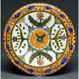 Carl Monzony. A slipware dish, 1895-1898, painted with stylised flowers within everted trailing