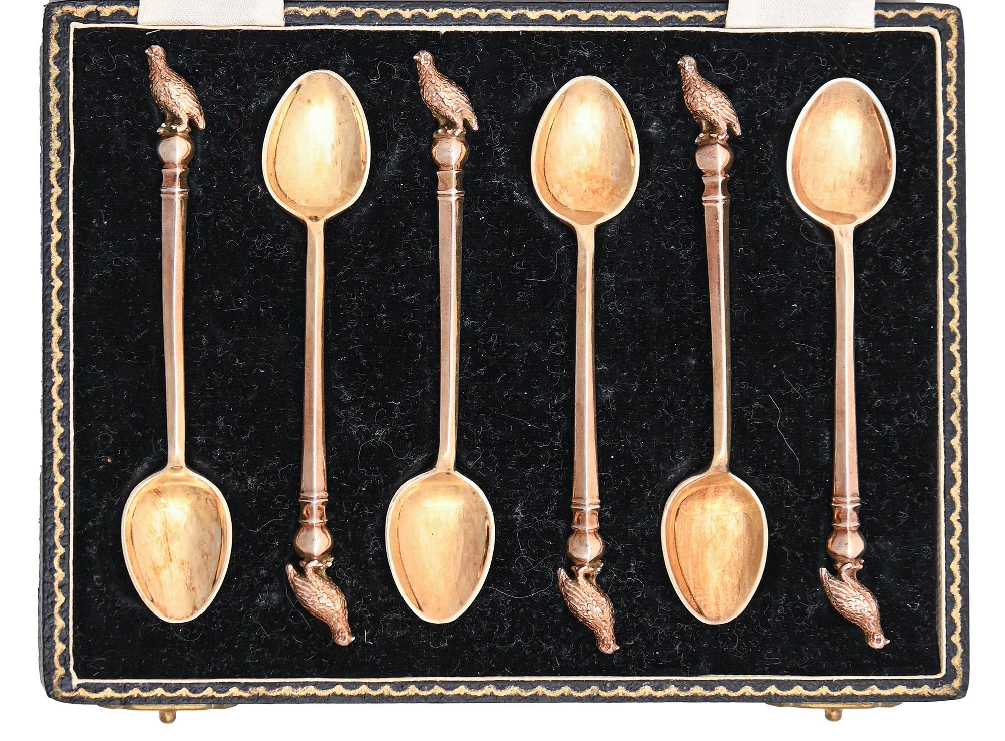 A set of six Elizabeth II silver gilt coffee spoons, with grouse terminal, by William Huckling