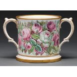 An earthenware loving cup, c1870, painted with cabbage roses and inscribed in gilt A Present from