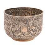 A Burmese silver repousse bowl, c1900, chased with a continuous band of animals in the jungle, the
