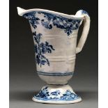 A Rouen faience ewer, 19th c, of helmet shape painted with flowers between trellis borders, 21cm h