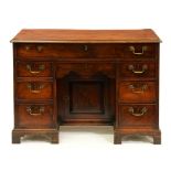 A George III mahogany kneehole dressing chest,  with figured top, 81cm h; 56 x 110cm Some rippling