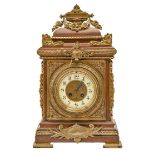 A French brass mounted oak bracket clock, with primrose enamel chapter ring and gong striking