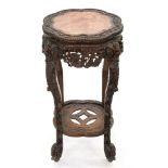 A Chinese carved hardwood stand, c1900, profusely carved with auspicious emblems, flowers, pink
